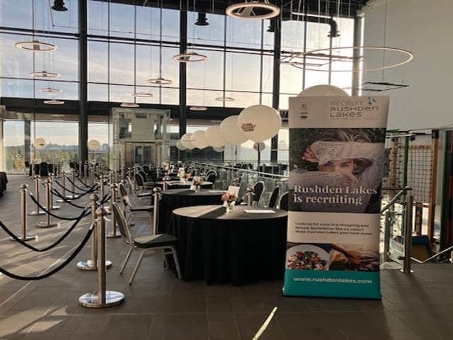 desks laid out with chairs in front in large room