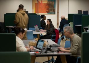 photos of men and women working in an open plan office